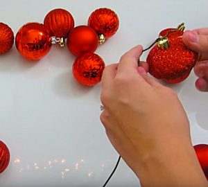 Try this DIY Christmas Ball Coat Hanger Wreath