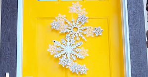 Learn to make this DIY Dollar Store Snowflake Door Hanging
