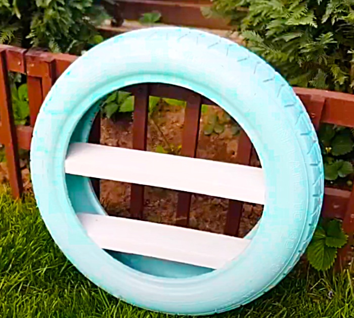 Add Recycled Pallet Boards To A Tire To make A DIY Garden Shelf Idea